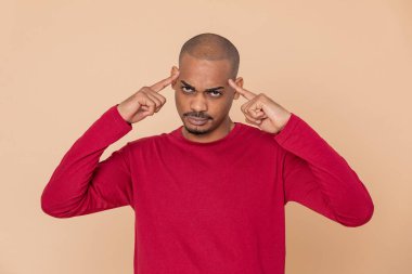 Sarı arka planda kırmızı formalı Afrikalı adam.