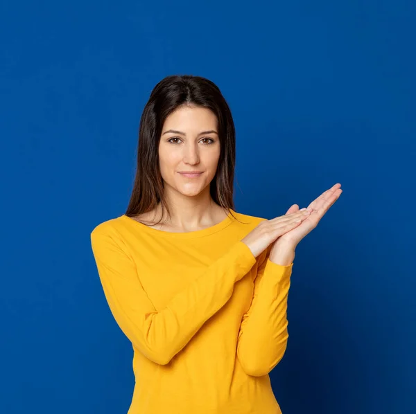 Mujer Joven Morena Con Una Camiseta Amarilla Sobre Fondo Azul —  Fotos de Stock