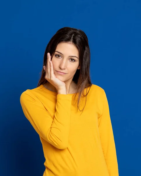 Brünette Junge Frau Mit Gelbem Shirt Auf Blauem Hintergrund — Stockfoto