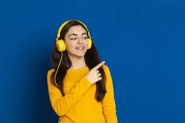 Chica Joven Morena Con Jersey Amarillo Sobre Fondo Azul —  Fotos de Stock