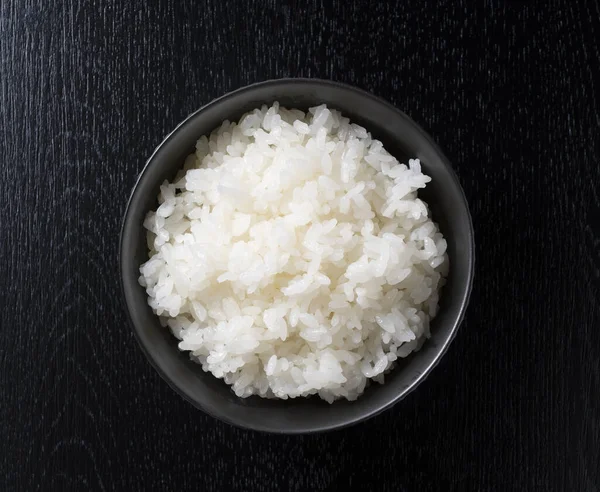 Take a bird's-eye view of the rice on the black background