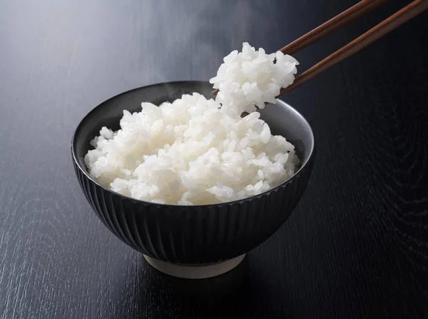 Scooping Rice Chopsticks Black Background — Stock Photo, Image