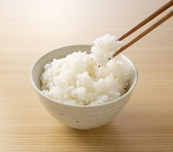 Close Shot Him Scooping Rice Chopsticks Wooden Background — Stock Photo, Image