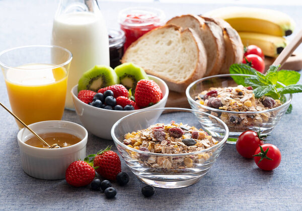 Images of a sumptuous breakfast of granola, bread, fruit and juice
