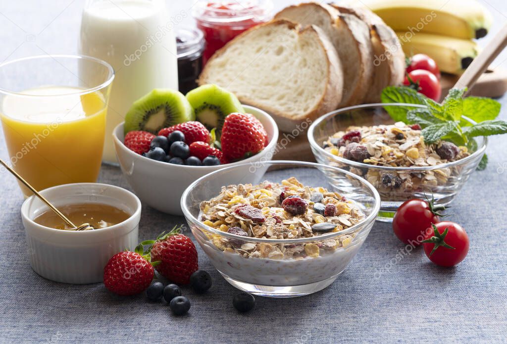 Images of a sumptuous breakfast of granola, bread, fruit and juice