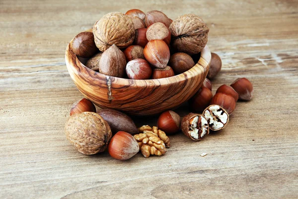 Large diversity of healthy nuts in wooden bowl