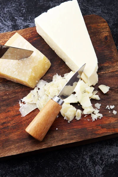 An aged authentic parmigiano reggiano parmesan cheese with chees — Stock Photo, Image