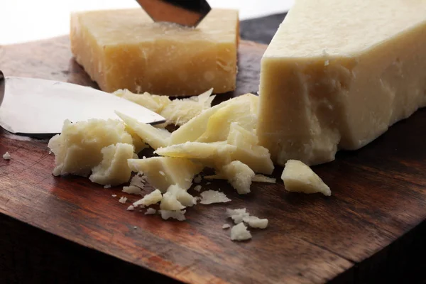 An aged authentic parmigiano reggiano parmesan cheese with chees — Stock Photo, Image