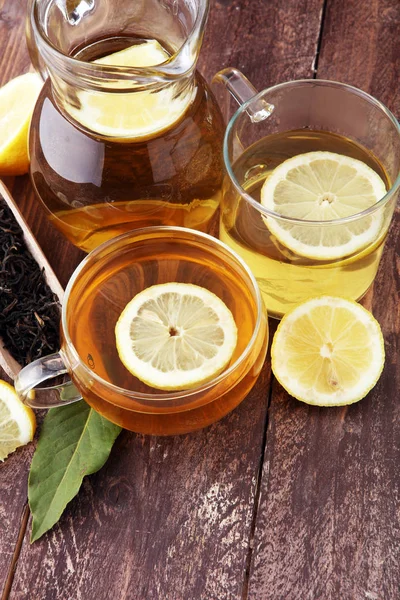 Hot tea in a transparent cup. Tea with lemon fruits. Warming dri