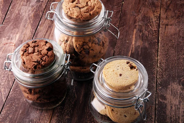 Chocolate cookies in a glass jar on white background — Stock Photo, Image
