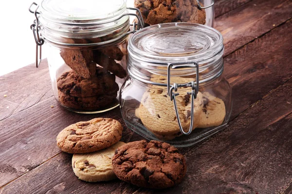 Chocolate cookies in a glass jar on white background — Stock Photo, Image