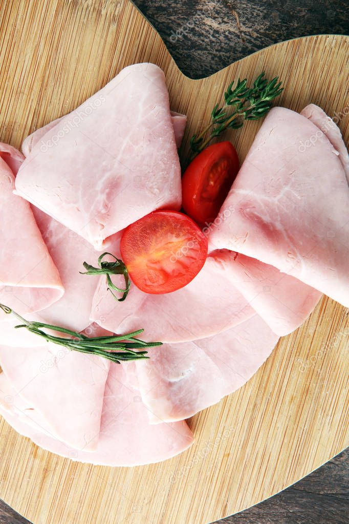 Sliced ham on wooden background. Fresh prosciutto. Pork ham slic