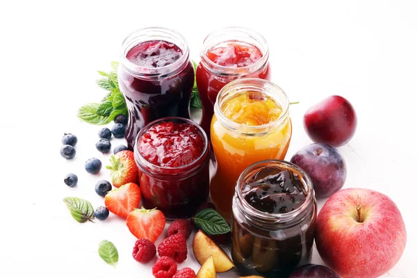 Assortment of jams, seasonal berries, plums, mint and fruits — Stock Photo, Image