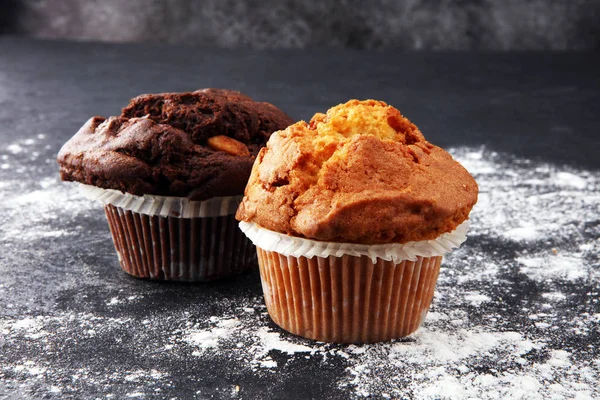 Chocolate muffin and nut muffin, homemade bakery on dark backgro