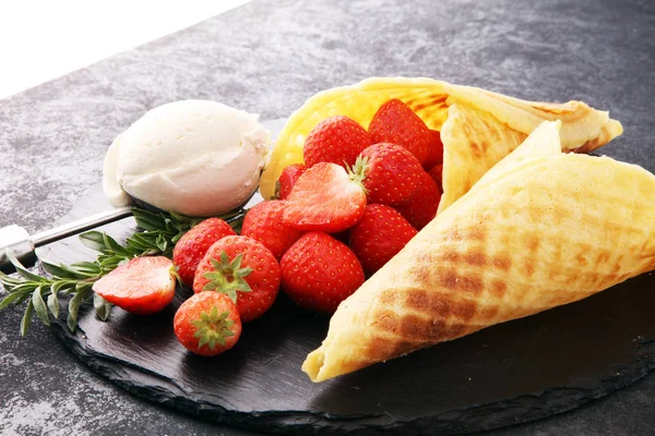 ice cream vanilla flavor and cones with fresh strawberry setup o
