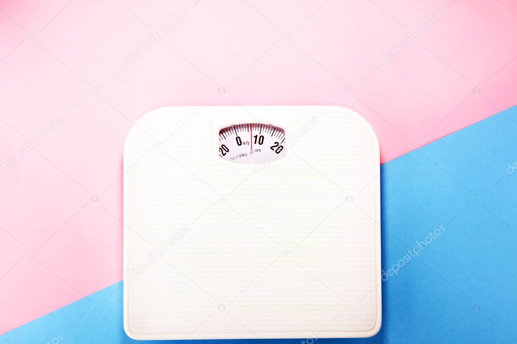 weight measure flat lay on colored paper.