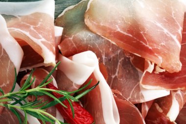 Italian prosciutto crudo or jamon with rosemary. Raw ham clipart