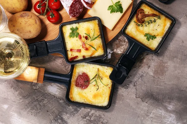 Lezzetli geleneksel İsviçre raclette peynir doğranmış kaynatın üzerinde erimiş