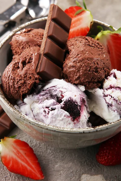 Chocolate coffee ice cream ball in a bowl and strawberry and van