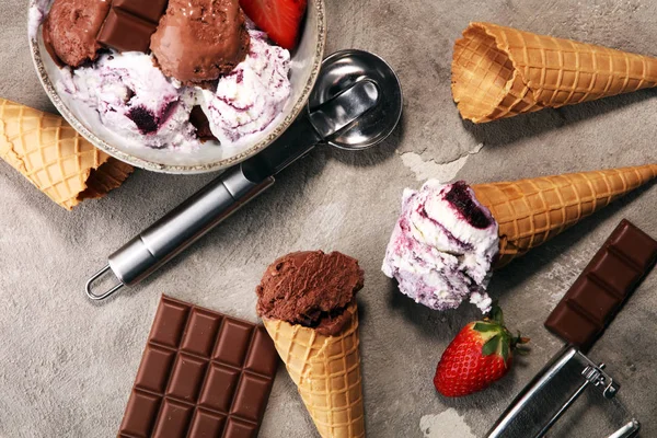 Chocolate coffee ice cream ball in a bowl and strawberry and van