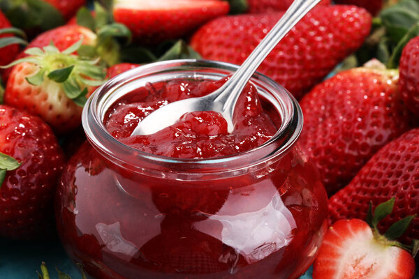 strawberry jam with fresh strawberries. marmalade on spoon and j
