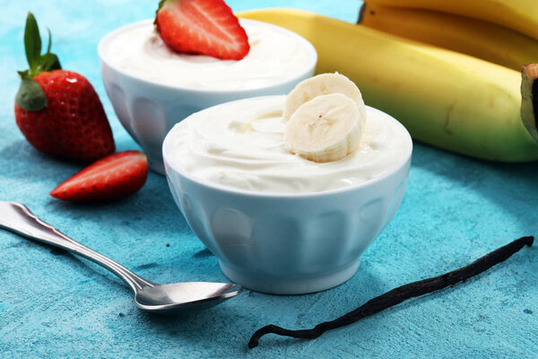 whipped cream with strawberry and banana. healthy yogurt