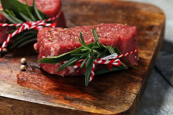 Raw beef fillet steaks with spices for bbq grilling.