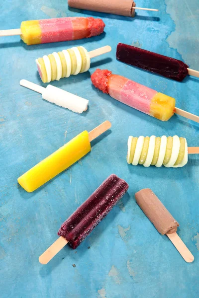 Colorful popsicle or Vanilla frozen yogurt or soft ice cream.