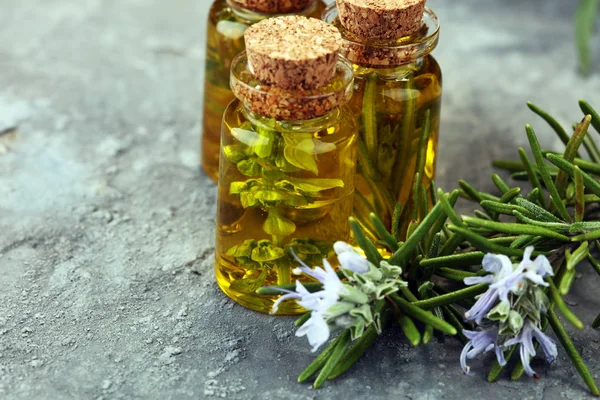 Lavender oil in a glass bottle on a background of fresh flowers. — Stock Photo, Image