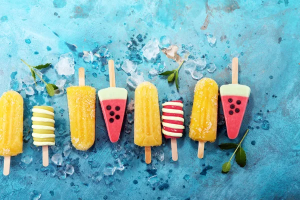 Colorful popsicle or Vanilla frozen yogurt or soft ice cream.