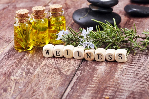 Lavender oil in a glass bottle on a background of fresh flowers. — Stock Photo, Image