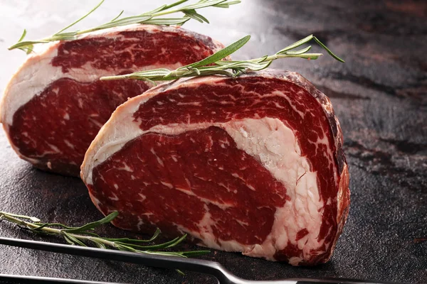 Raw fresh meat Ribeye Steak, seasoning and meat fork on rustic b — Stock Photo, Image