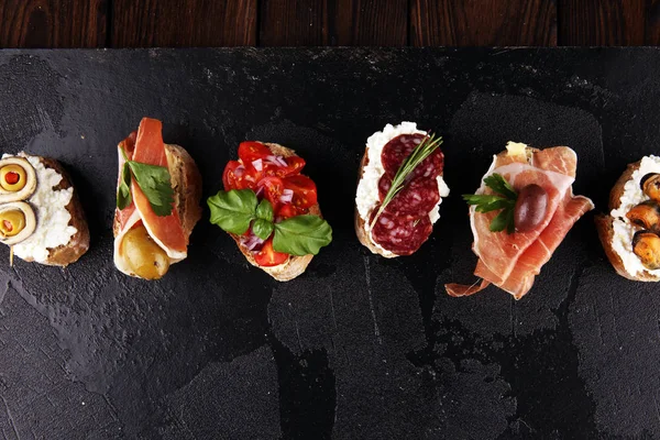 Appetizers table with italian antipasti snacks and wine in glass — Stock Photo, Image