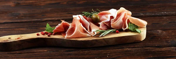 Italian prosciutto crudo or jamon with rosemary. Raw ham with sp — Stock Photo, Image