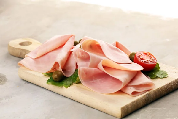 Sliced ham on wooden background. Fresh prosciutto cotto. Tasty P