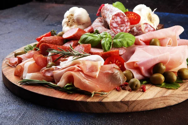 Bandeja de comida com delicioso salame, pedaços de presunto cru fatiado — Fotografia de Stock