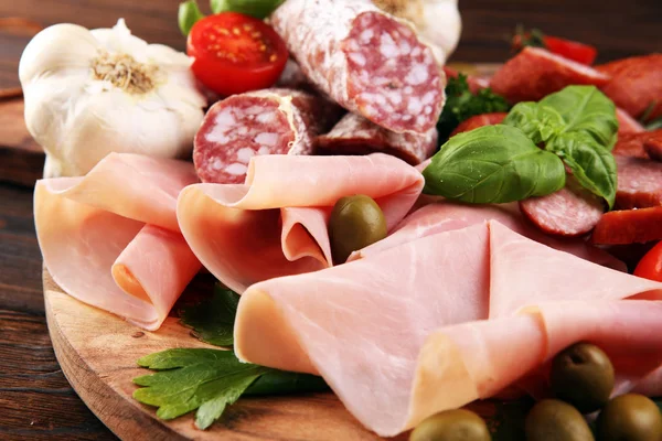 Bandeja de comida com delicioso salame, pedaços de presunto cru fatiado — Fotografia de Stock