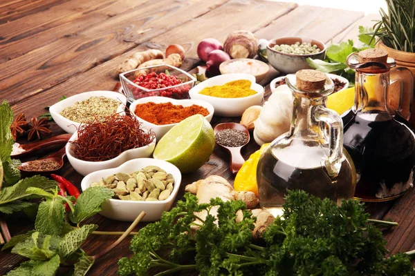 Especias y hierbas en la mesa. Comida e ingredientes de cocina con aceite — Foto de Stock