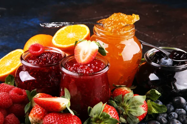 Assortment of jams, seasonal berries jelly, mint and fruits and — 스톡 사진