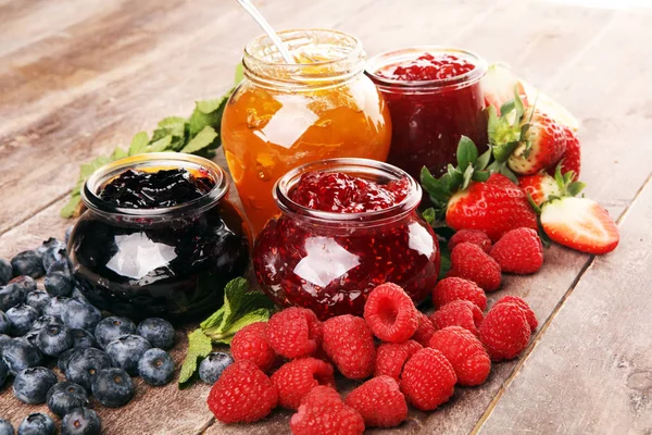 Assortment of jams, seasonal berries jelly, mint and fruits and — 스톡 사진