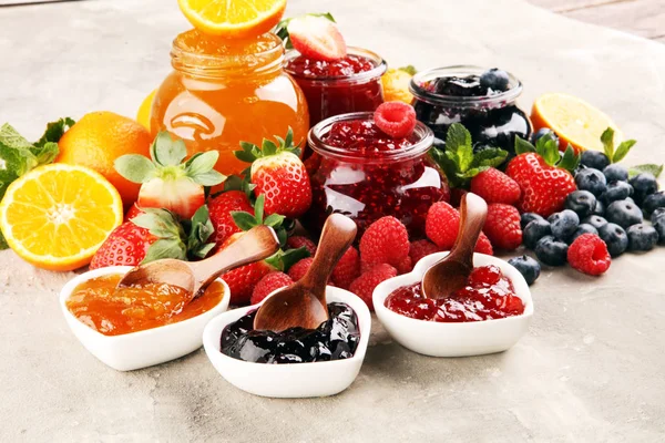 Assortment of jams, seasonal berries jelly, mint and fruits and — 스톡 사진