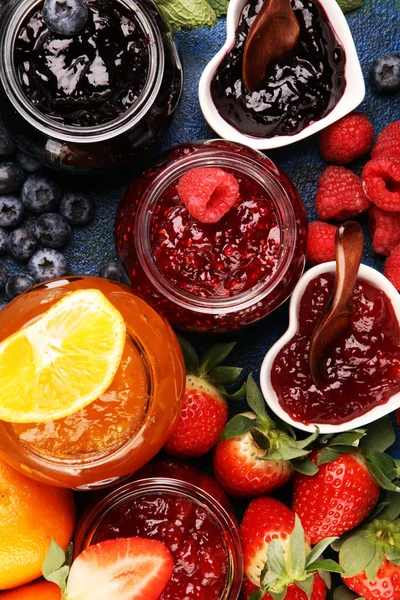 Assortment of jams, seasonal berries jelly, mint and fruits and — 스톡 사진