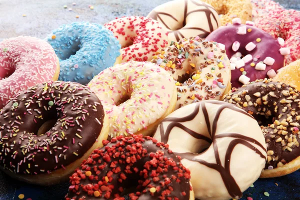 Assorted donuts with chocolate frosted, pink glazed and sprinkle — Stock Photo, Image