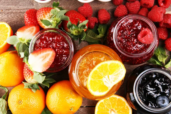 Assortment of jams, seasonal berries jelly, mint and fruits and — 스톡 사진