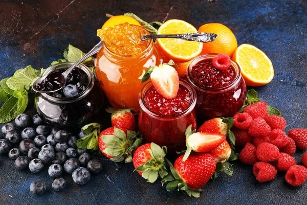 Assortment of jams, seasonal berries jelly, mint and fruits and — 스톡 사진