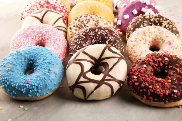 Assorted donuts with chocolate frosted, pink glazed and sprinkle Royalty Free Stock Photos