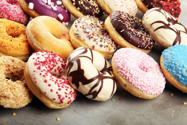 Assorted donuts with chocolate frosted, pink glazed and sprinkle Royalty Free Stock Images