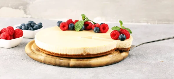 Homemade cheesecake with fresh raspberries and mint for dessert