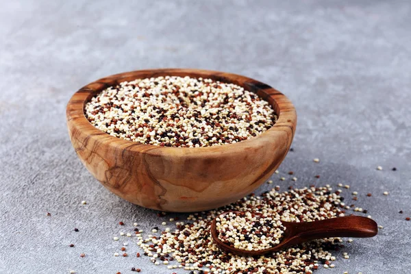 Set of quinoa Red, white and brown quinoa in a wooden spoon. hea
