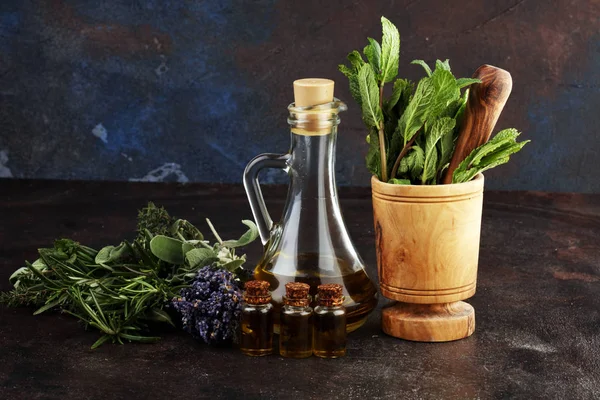 Fresh herbs from the garden and the different types of oils for